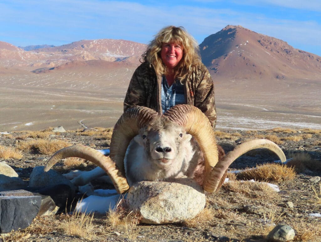 Hunting Consortium client with her Marco Polo Sheep Hunting trophy from Tajikistan.