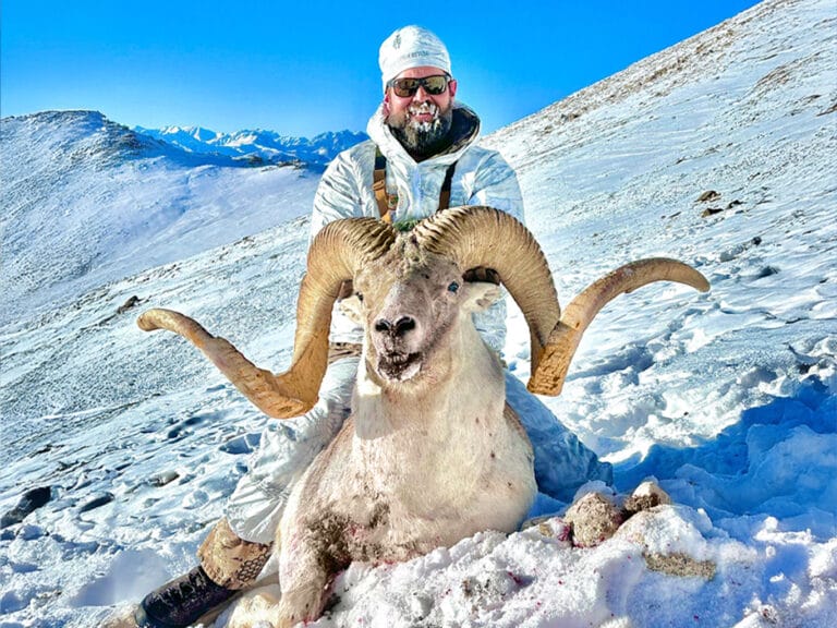Hunting Consortium client in the Pamir Mountains of Tajikistan with Marco Polo Sheep Hunting trophy.