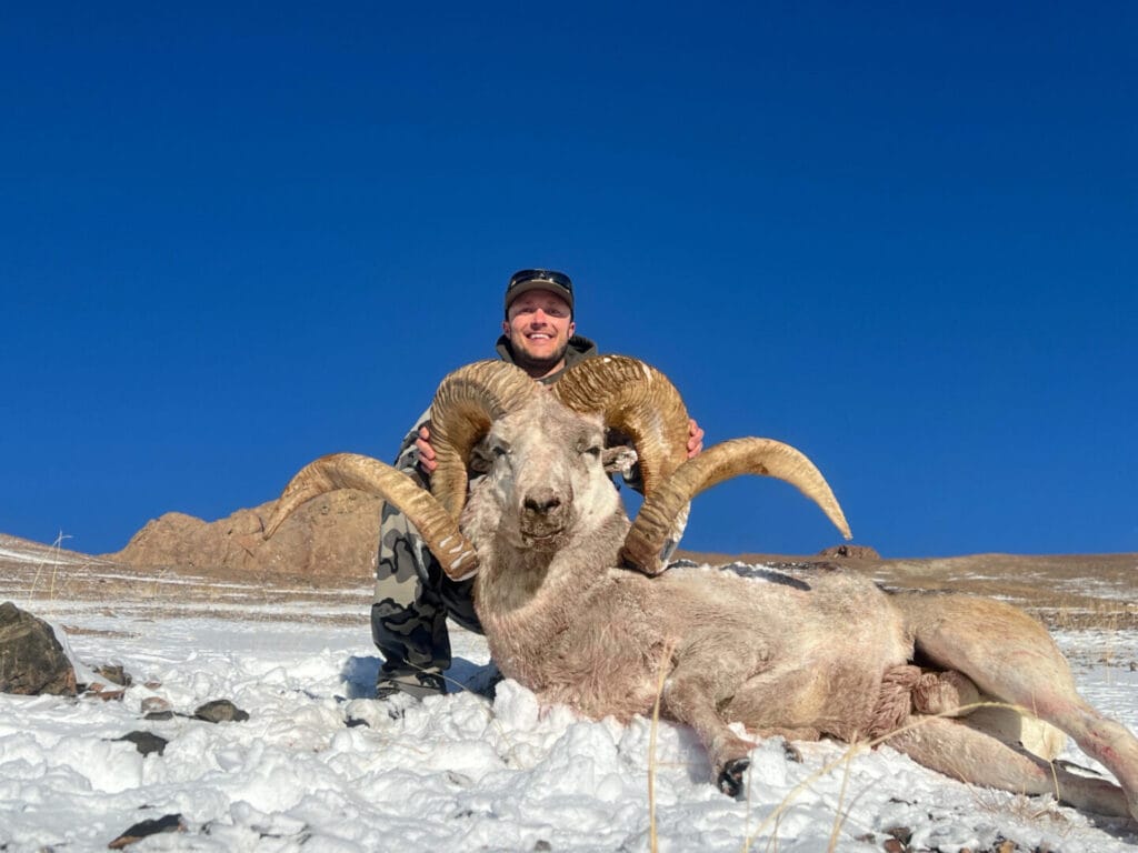 Hunting Consortium client in the Pamir Mountains of Tajikistan with 63 inch Marco Polo Sheep Hunting trophy.