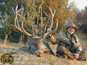 A picture of a man Mideastern Red Stag Hunting in Turkey. He is smiling on his Turkish hunt, and glad he chose to go wild hunting Turkey! Best Wild Hunting ourfitters in Turkey and Asia