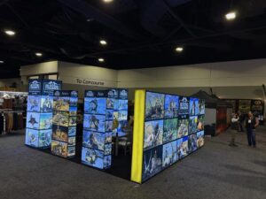 Dallas Safari Club 2026 Hunting Consortium booth along the concourse featuring illuminated panels of global big game hunting trophies. DSC 2026.