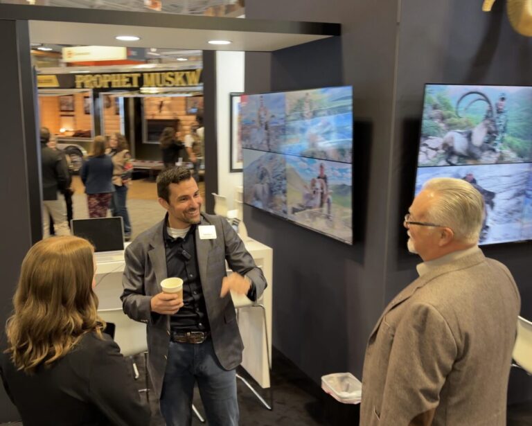 The HuntCon team discussing international hunting opportunities with visitors at The Hunting Consortium booth during the Safari Club International convention.