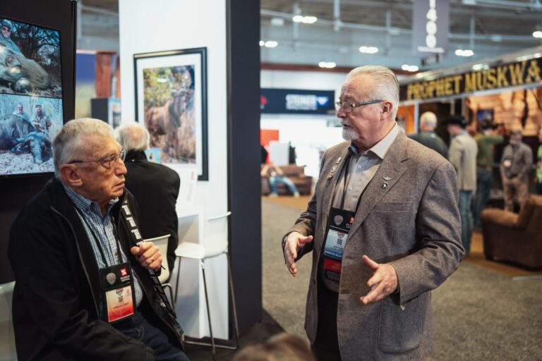 Bob Kern of The Hunting Consortium speaking with a potential client at the Safari Club International convention about international hunting opportunities.