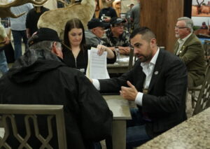 Rob Kern consulting with clients at hunting convention booth