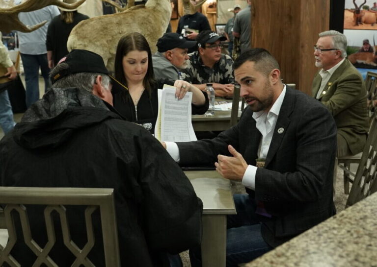Rob Kern consulting with clients at hunting convention booth