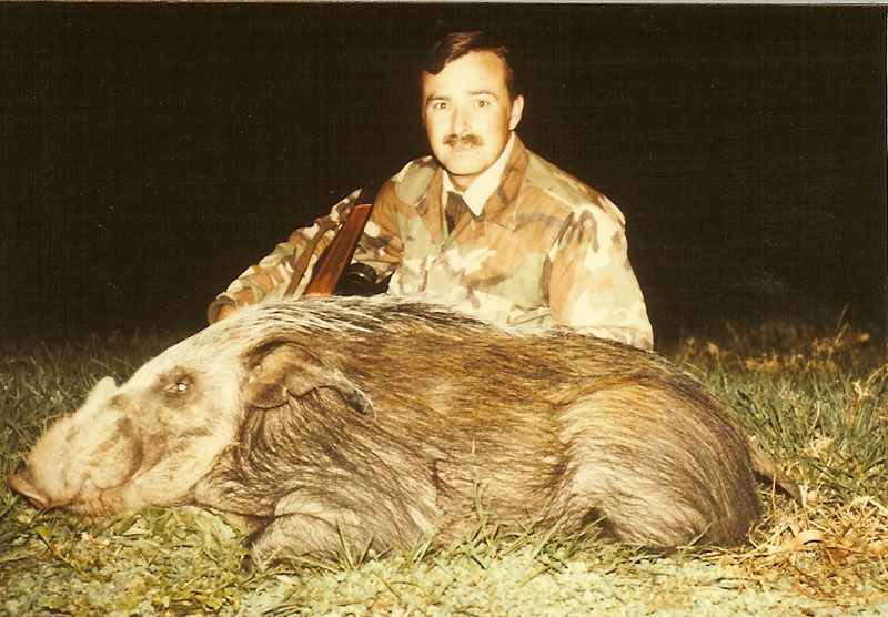 Bob Kern with a harvested wild boar during an early international hunt, representing decades of Hunting Consortium field experience.